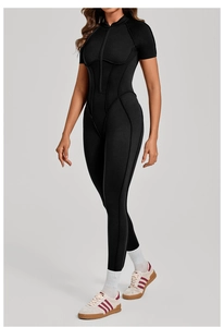 Detail of black athletic bodysuit featuring high collar zipper and contouring stitch lines