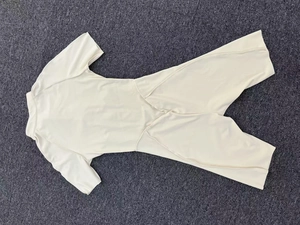 Close-up of beige athletic bodysuit back showing stand collar and professional seams