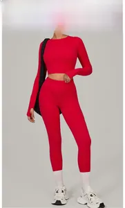 Detail of red high-elasticity yoga set featuring cropped long sleeve top and leggings