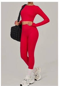 Detailed view of women's red two-piece yoga set with long sleeve crop top and high waist leggings