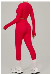 Detail of red athletic set with thumb holes on long sleeves and high waist leggings