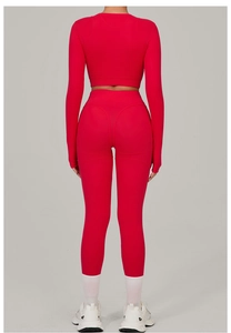 Rear view of tight red yoga set featuring high-waisted leggings and long sleeve crop top