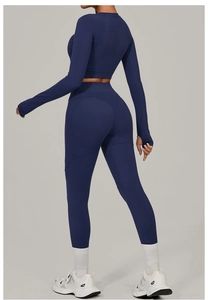 Detail view of navy blue high-stretch yoga set featuring thumbholes and lifting leggings