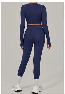 Detail view of navy blue yoga set showing thumb holes and butt-lifting curved seams
