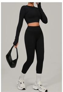 Detail of black brushed yoga set featuring long sleeve crop top and high waist gym leggings