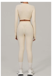 Detail view of beige yoga set featuring high-waisted leggings with butt-lifting seam design