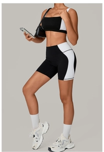 Detail of black and white high-stretch fitness set with sports bra and biker shorts