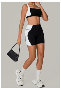 Detail of square neck color-block yoga bra and high waist shorts on fitness model
