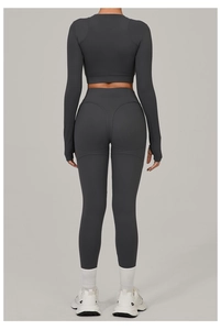 Detail view of charcoal gray yoga set showing thumbhole cuffs and heart-shaped booty seam