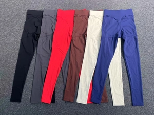Vertical stack of multi-colored high waist yoga leggings with peach butt lifting seam