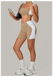 Detail of khaki and white patchwork yoga set showing high waist shorts and sports bra