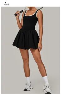 Detail of a black backless tennis dress with white trim and athletic pleated bubble hemline