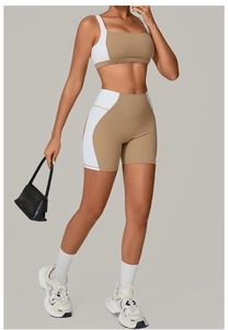Close-up of women's two-piece yoga set featuring brown and white color-block design