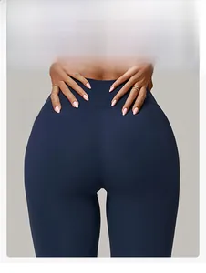 Detail of high-waisted navy yoga leggings featuring butt-lifting seams and matte fabric