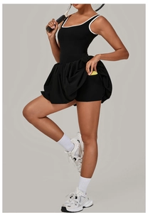 Detail view of black tennis dress with white trim and functional side pocket for ball