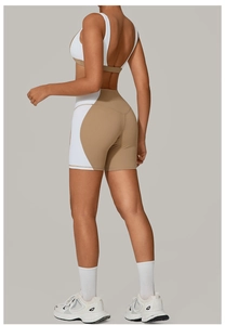 Close-up of backless sports bra and high-waist yoga shorts in khaki and white