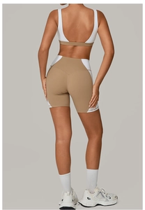 Back view of a white and khaki two-tone yoga set with open back sports bra and high waist shorts