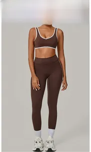 Brown high-waisted yoga leggings and V-neck sports bra set with white contrast piping details