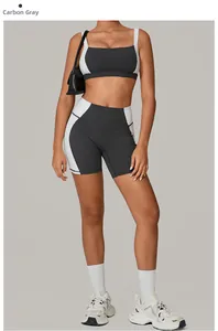 Close-up of charcoal grey and white yoga set featuring racerback bra and biker shorts