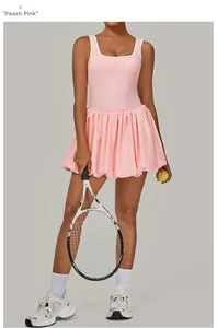 Detailed view of backless tennis dress in peach pink with white contrast trim details