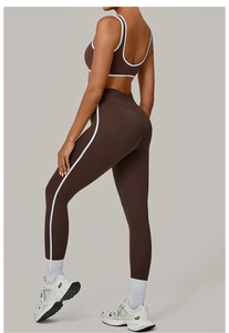 Detail view of brown yoga set with white contrast trim on sports bra and leggings