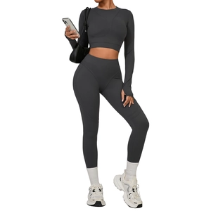 Dark grey tight-fitting yoga set with long sleeve crop top and high waist leggings