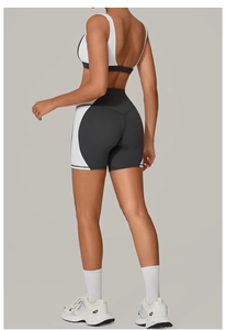 Back view of black and white color block yoga set with sports bra and high waist shorts