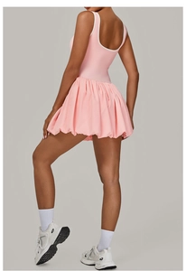 Detail of pink sports dress showing a deep U-shaped back with white contrast binding