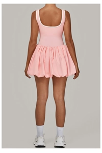 Detail view of pink bubble skirt back with white contrast trim and racerback design