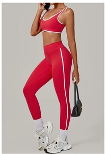 Detail of red yoga set featuring white contrast piping and high-elastic sports fabric