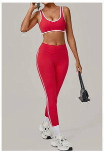 Detail of red yoga set showing white contrast trim and high-stretch seamless fabric