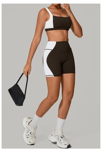 Detail of two-piece sports set featuring black and white contrast stitching and square neck