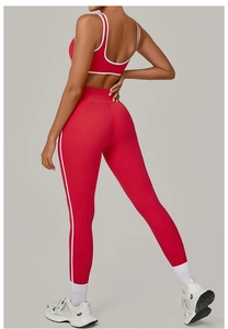 Detail view of red yoga set with white contrast trim and high-waist lifting fit