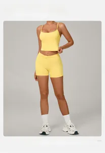 Front view of yellow yoga set with crop top and high waist shorts on a model