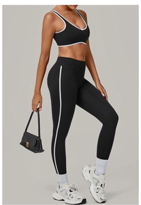 Detail of black seamless yoga set featuring white contrast binding and high waist fit