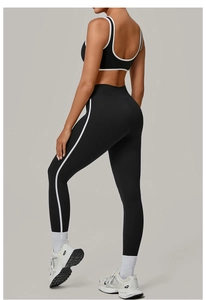 Detail of high-stretch contrast binding yoga set showing racerback bra and side-stripe leggings