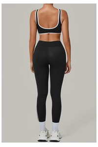 Detail of cross-back yoga bra and high-waist leggings with white piping accents