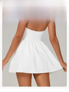 Close-up of a white tennis dress with pleated bubble hem and open back detail