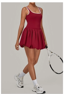 Detail of burgundy backless athletic tennis dress with white piping and bubble hem skirt