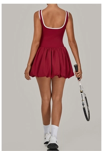 Detail of burgundy backless sports dress with white piping and flared bubble hemline