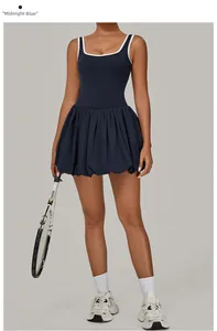 Detail view of midnight blue sports tennis dress with white contrast trim and pleated hem