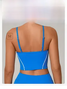 Detail view of adjustable back straps and silver buckles on bright blue yoga sports bra