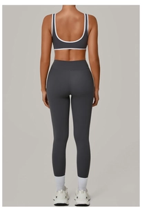 Back view of a grey yoga set featuring a racerback top with white contrast piping