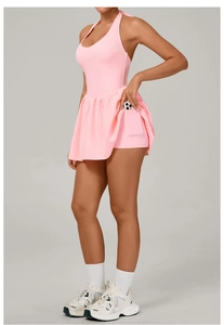 Detail view of pink tennis dress with halter neck and side pocket for phone in built-in shorts