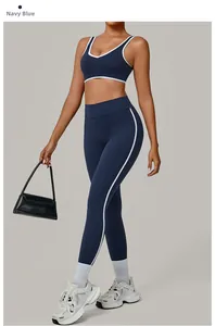 Detail of navy blue yoga set featuring white contrast piping and high-waist sports leggings