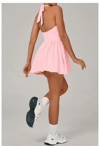 Detailed back view of a pink halter neck tennis dress with pleated skirt for women