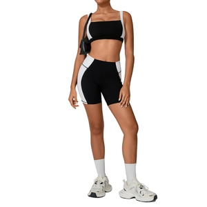 Two-piece black and white patchwork yoga set with square neck sports bra and bike shorts