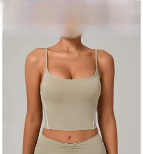 Detail of flax-colored yoga vest with dual shoulder straps and white side ribbon piping
