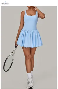 Detail view of sky blue backless tennis dress with white trim and pleated skirt hem