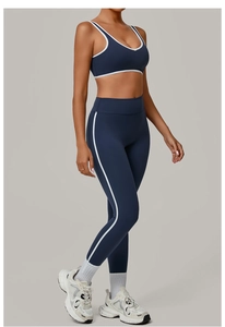 Detail of navy blue yoga set with contrast white piping showing high-stretch fabric fit